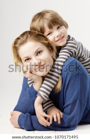Mother and her little son hugging looking at the camera, 