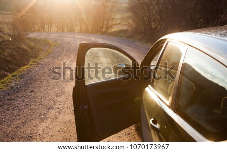 car on a dirt road at sunset - roadtrip