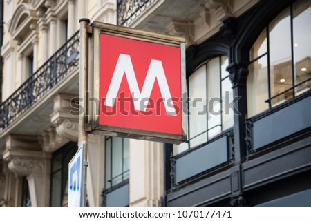 Traditional metro sign on the backdrop of a beautiful old building. Italian cityscape