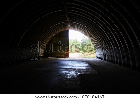 Interior of abandoned old military hangar for storage and maintenance of fighter jets and other military aircraft