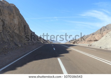 Vintage toned scenic desert highway at sunset