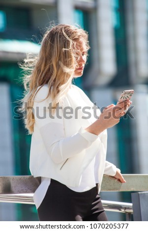 young business woman working with smart  phone in the city business center 