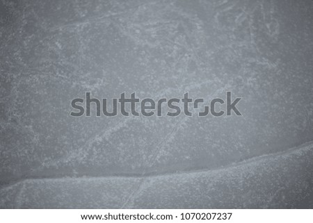 nature detail - frozen lake close up with cracks across and fresh snow, on a winter day outdoors in POland, Europe on a winter day