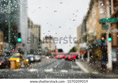Driving through San Francisco on a rainy day; rain drops on the windshield; California