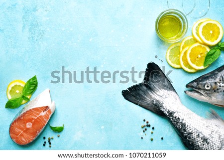 Raw organic trout on a blue slate,stone or concrete background.Top view with copy space.