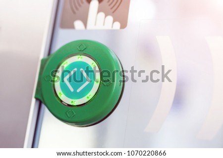 Green round touch button with arrows. Transparent door between carriages in intercity train
