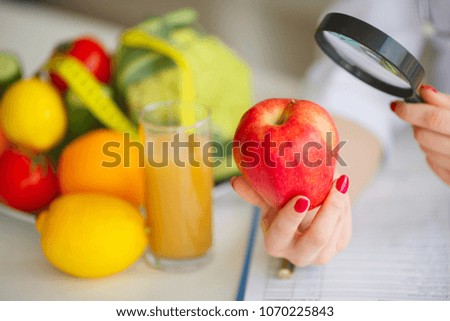 Conceptual Photo Of A Female Nutritionist With Fruits On The Desk