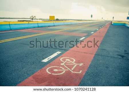 a bike lane along the colorful bridge in the bright sky