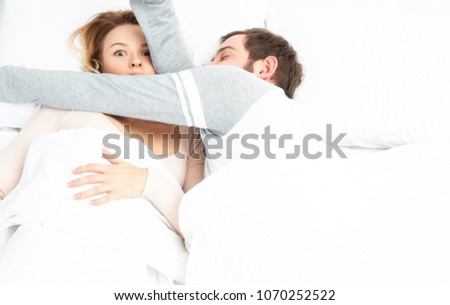 Young couple sleeping together in bed