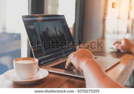 Man hands typing on laptop on table in coffee shop with len flare and warm filter with free wifi ,concept for freelance can working any time anywhere