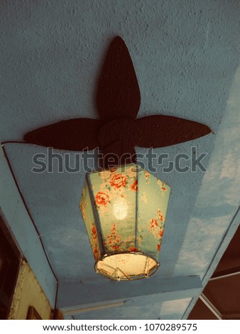 Traditional chinese flower red and light blue fabric lantern on blue concrete ceiling