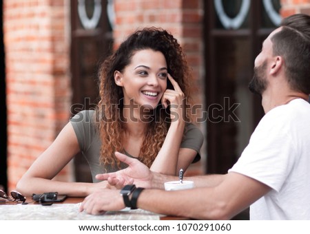 Portrait of a  happy couple sitting down at a cafe