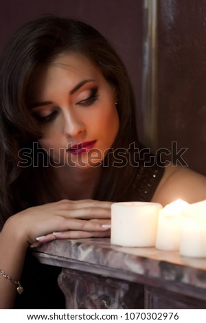 portrait of a beautiful brunette with candles