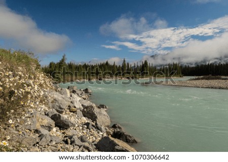 Glacial waters flowing down the river in the Canadian Rocky Mountains.