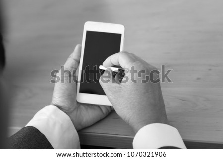A businessman holding a smart phone 