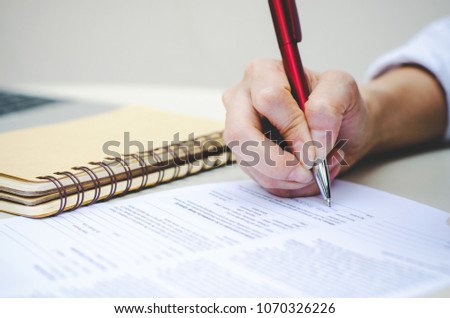 attractive business woman hands use pen signing on paper or writing note or examination test on table at outdoor.