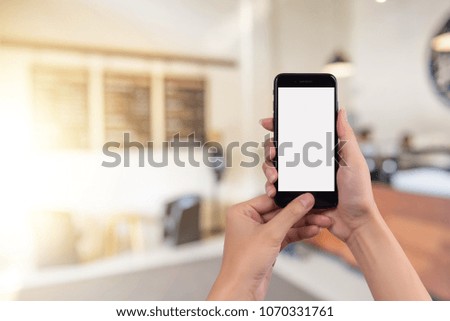 Cropped shot view of woman's hands holding smart phone with blank copy space screen for your text message or information content.