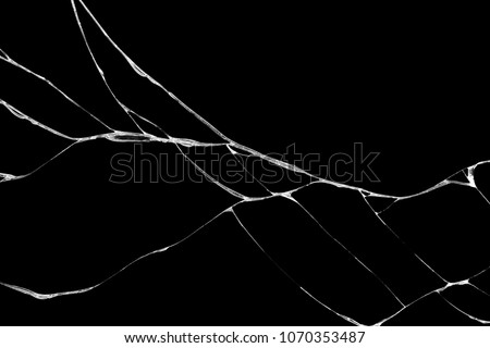 Art of wrinkles and cracks of glass caused by smashing and falling bumps. isolated on black background, This crack can be used as a pattern of floor tiles, in one corner also means loss and discord Royalty-Free Stock Photo #1070353487