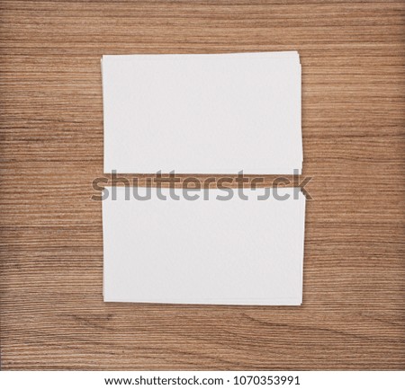Mockup of two horizontal business cards at light wooden background
