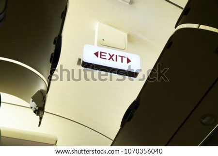 The Emergency Exit Sign on the ceiling of Airplane.