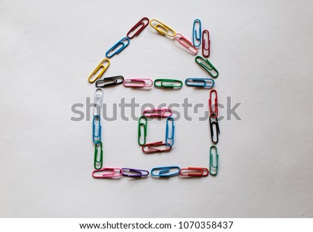 Colorful paper clip put on the white background as the house. Realty theme icon.