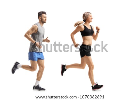 Full length profile shot of a young man and a young woman running isolated on white background Royalty-Free Stock Photo #1070362691