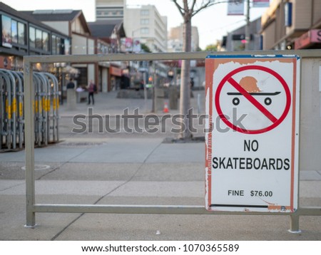 “No skateboards” warning sign at an urban area, comes with a fine.