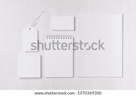 Corporate identity set of blank white stationery on soft white wood board. Template for branding, business presentations and portfolios.