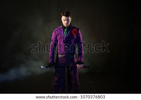 Showman. Young male entertainer, presenter or actor on stage. The guy in the purple camisole and the cylinder. Bright tailcoat, suit