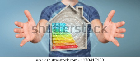 Businessman on blurred background using 3D rendering energy rating chart in a wooden house