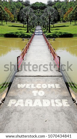 Welcome to Paradise signage imprint on the crossing into a green park. 
