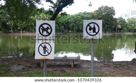 Prohibition Signs at lumphini park thailand . this is rule for use together park . Do not bring your pet,Do not drink alcohol, Do not litter.