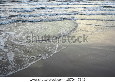 Wave on seashore on cloudy sky in morning, Sea shore after rain