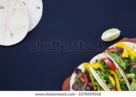 Mexican street tacos flat lay composition with beef and vegetables. Flat top view.