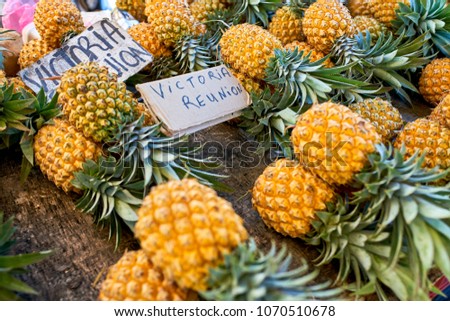 famous victoria pineapple on local market of reunion island Royalty-Free Stock Photo #1070510678