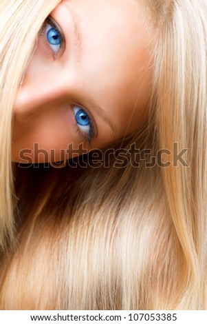 Blond Hair. Blonde Girl with Blue Eyes. Healthy Long Blond Hair. Hair Extension Royalty-Free Stock Photo #107053385