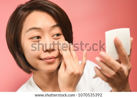 asian girl making-up puff powder