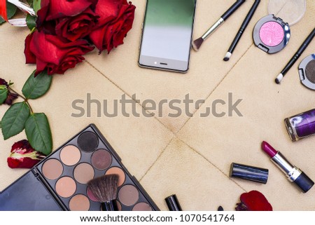 cosmetics and flowers on a leather sofa,  all necessary for women's beauty. place for text 
