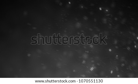 Blur falling snow  texture isolated on the black background for overlay design.