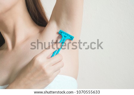 Hands are shaved, armpits or plucking the armpits by using a razor, Depilation and skin care concept. Royalty-Free Stock Photo #1070555633