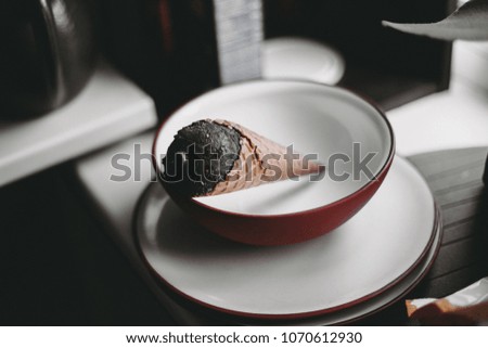 Black ice cream waffle in white bowl
