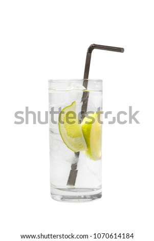 Transparent cocktail in a tall glass with ice cubes with two slices, lime quart, soda, aeration with a straw. Side view Isolated white background. Drink for the menu restaurant, bar, cafe