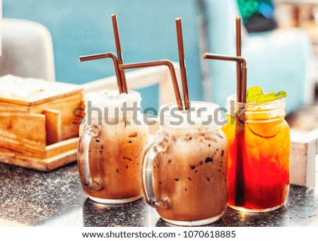Ice coffee and Ice tea with lemon slices and mint on a table with empty space for text.Travel vacation concept. Summer background