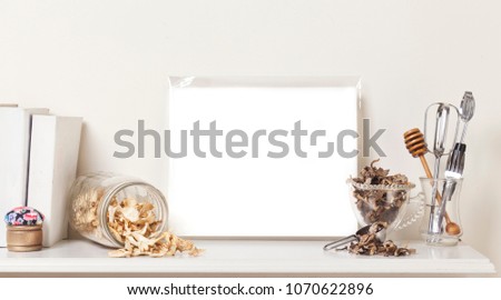 A collection of decorative knick-knacks on a shelf with blank artwork space for copy or artwork.