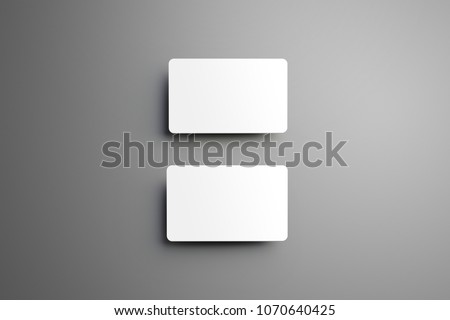 Universal mockup of a two  bank (gift) cards placed vertically with shadows on a gray background. Top of view.
