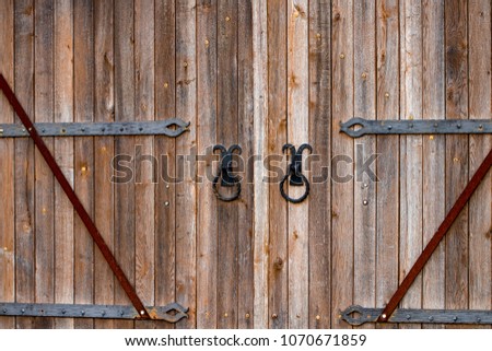 wooden gate with wrought iron elements close up.