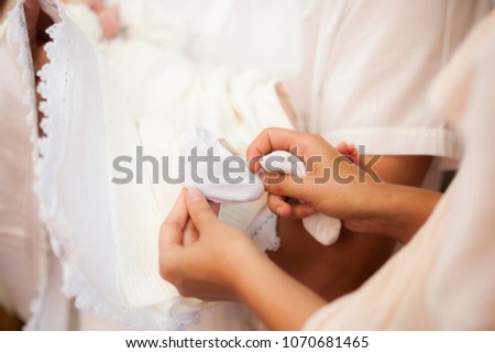 Close-up image of white sock wearing on little boy foot in church