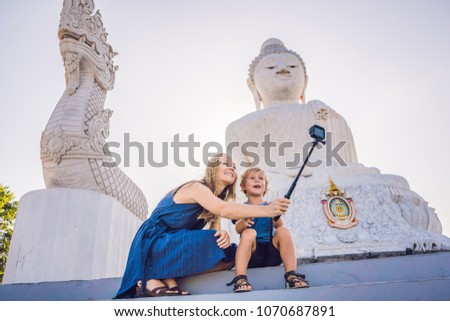 Mother and son tourists on the Big Buddha statue. Was built on a high hilltop of Phuket Thailand Can be seen from a distance