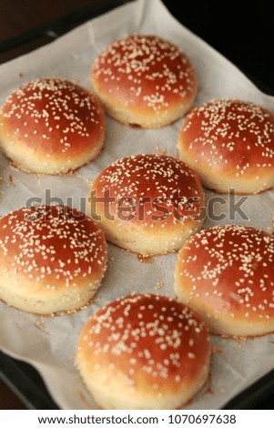 Homemade kosher Burger buns on a baking tray