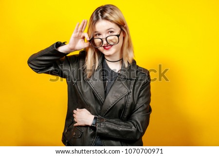 Beautiful smiling young woman touching eye glasses